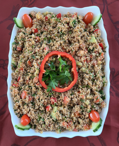 Buntes Bulgur-Gemüse-Gericht mit Paprika, Gurken und Kirschtomaten, garniert mit Petersilie.