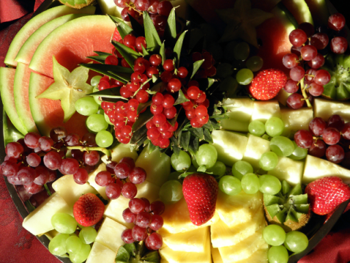 Bunte Obstplatte mit Wassermelonen, Trauben, Erdbeeren und Ananasstücken.